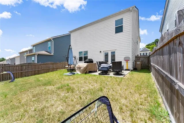 a view of a house with swimming pool and sitting area