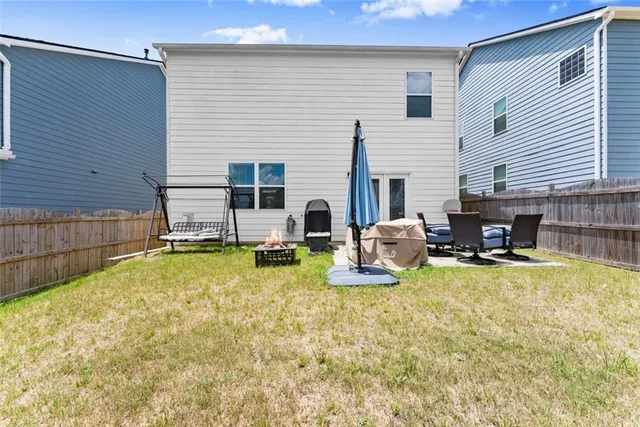 a backyard of a house with garden and barbeque oven