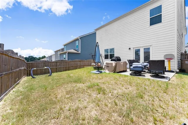 an aerial view of a house with swimming pool and lake view
