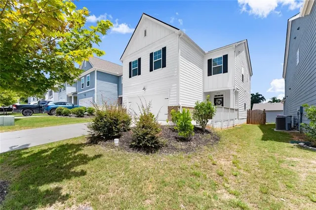 a front view of a house with garden