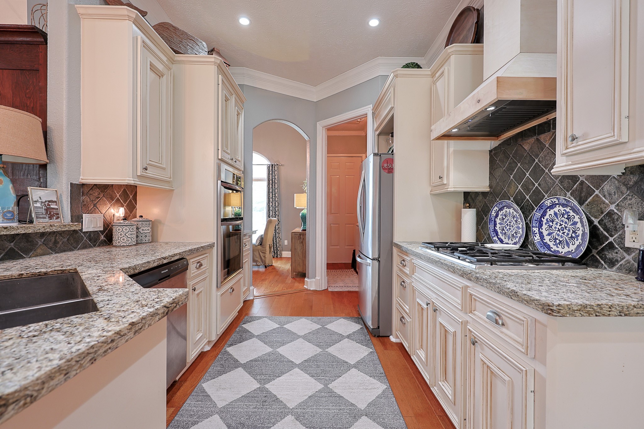 4704 Donald Street Seabrook, TX 77586 - Photo 19 of 42 a kitchen with stainless steel appliances granite countertop a stove and a sink