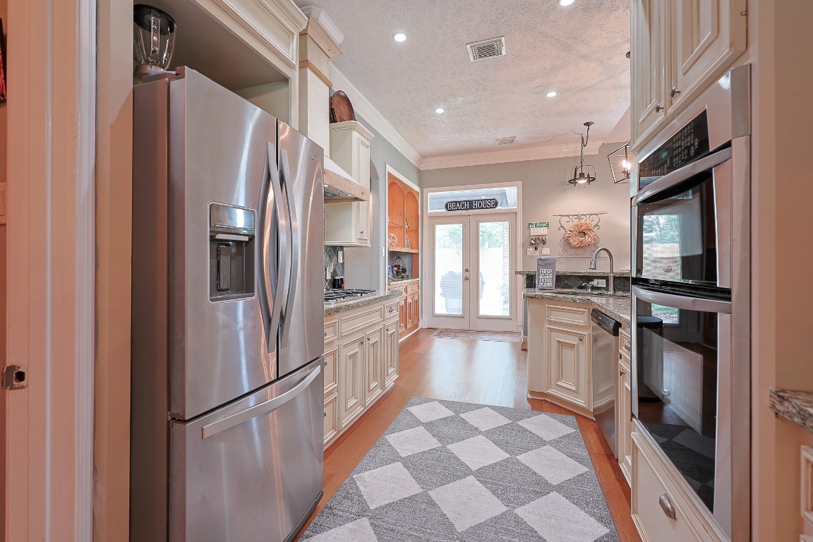 4704 Donald Street Seabrook, TX 77586 - Photo 20 of 42 a kitchen with stainless steel appliances granite countertop a refrigerator and a sink