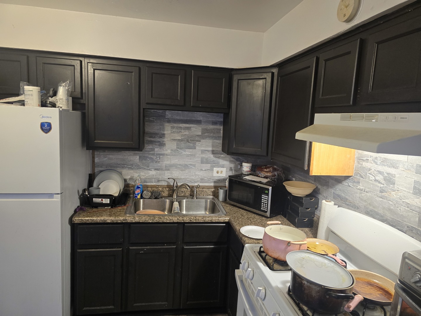 173 Williamsburg Road Country Club Hills, IL 60478 - Photo 3 of 22 a kitchen with a sink a stove and wooden cabinets