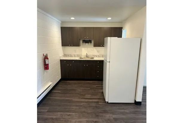 a view of kitchen with refrigerator and microwave