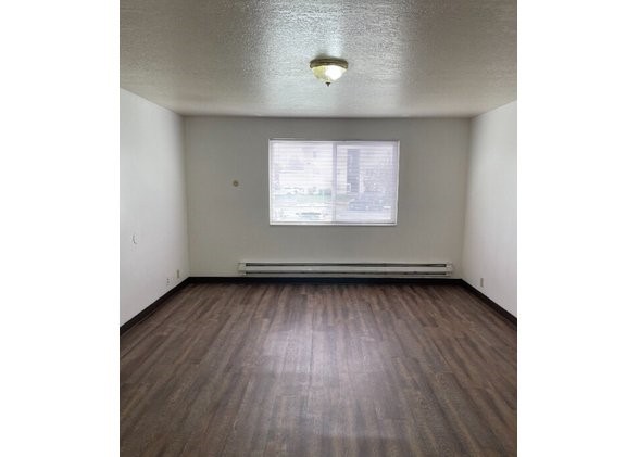 160 North 1st Street Teton, ID 83451 - Photo 4 of 11 a view of a room with wooden floor and a window