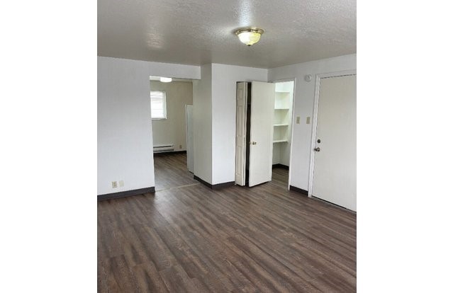 160 North 1st Street Teton, ID 83451 - Photo 5 of 11 a view of an empty room with wooden floor