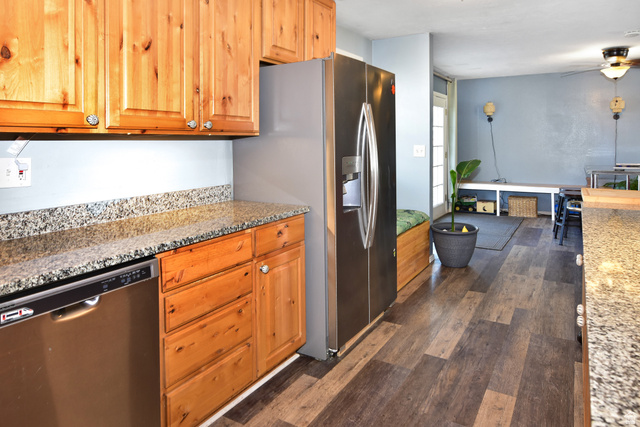 315 Park Street Inkom, ID 83245 - Photo 9 of 28 Kitchen featuring wood-finish cabinetry, speckled countertops, and stainless steel dishwasher