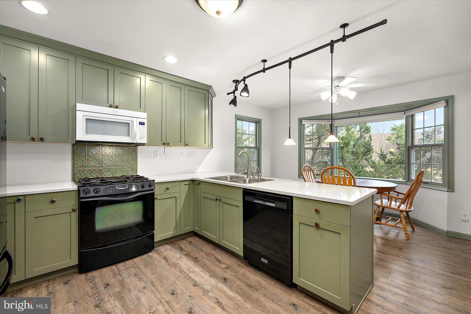 9554 Millard Long Road Westover, MD 21871 - Photo 12 of 69 a kitchen with kitchen island a sink stove and cabinets