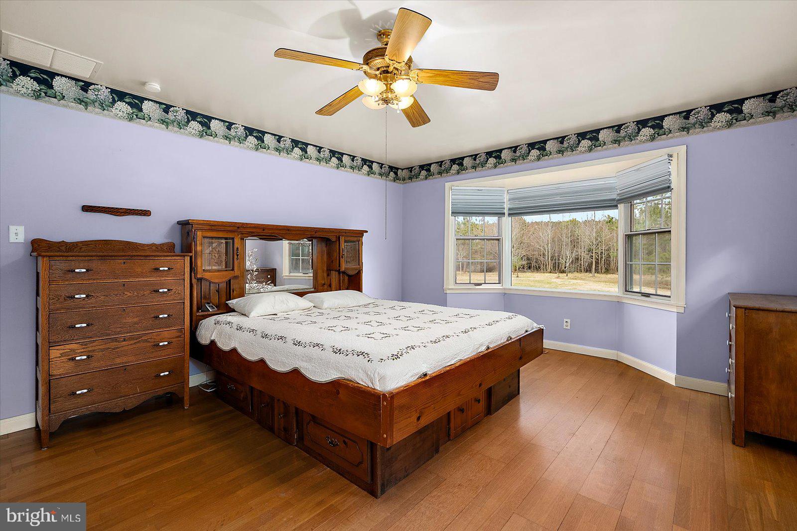 9554 Millard Long Road Westover, MD 21871 - Photo 18 of 69 a bedroom with a bed and a chandelier