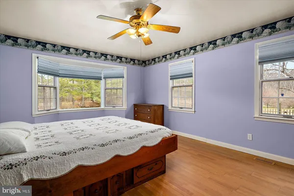 an empty room with wooden floor and entryway