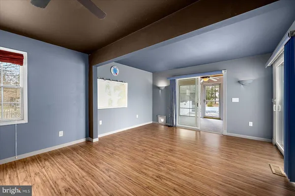 a hallway with a large white cabinet a rug and a mirror