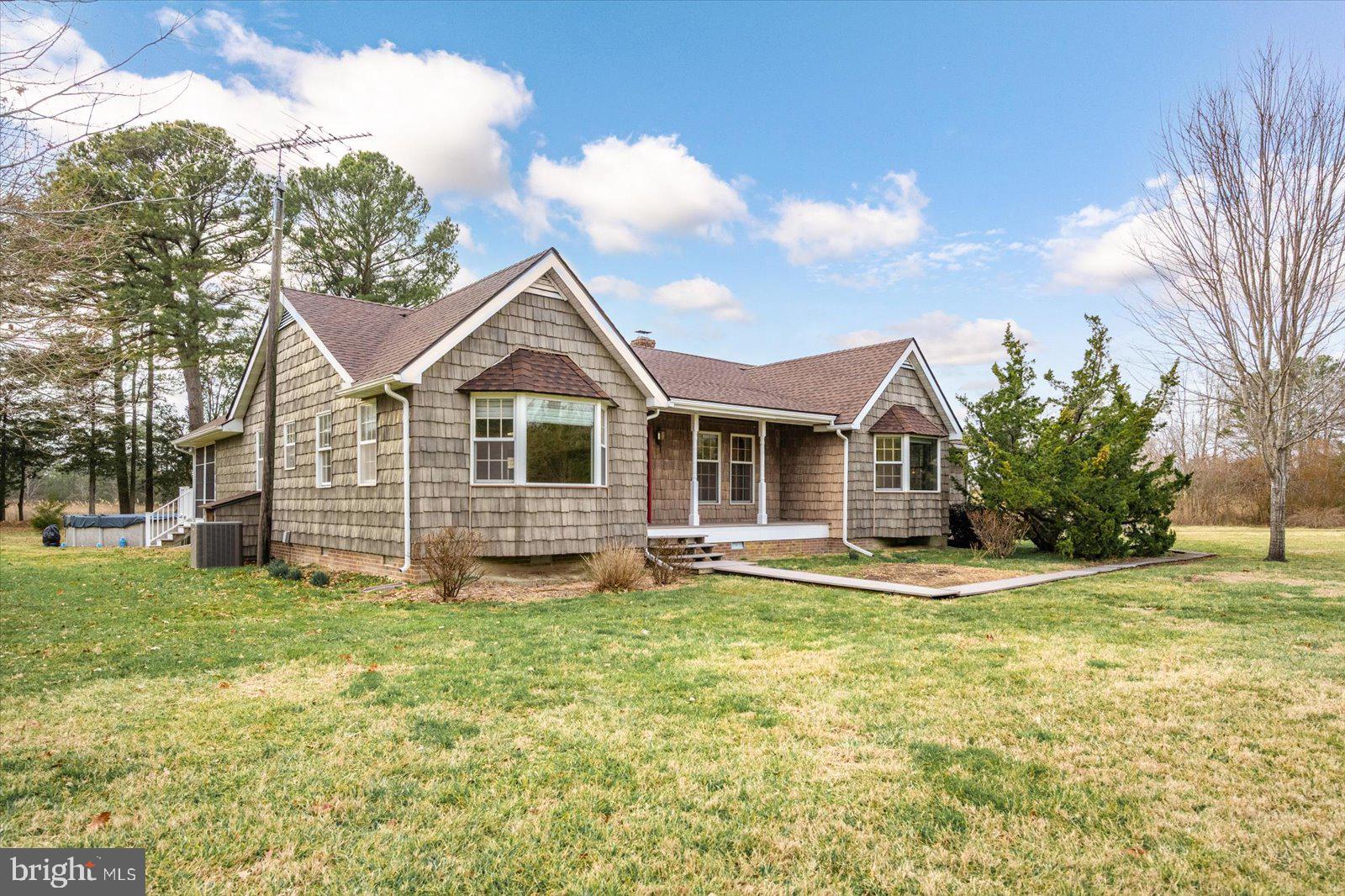 9554 Millard Long Road Westover, MD 21871 - Photo 3 of 69 a front view of a house with a yard and garage