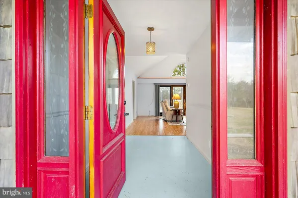 a living room with furniture two window and a fireplace