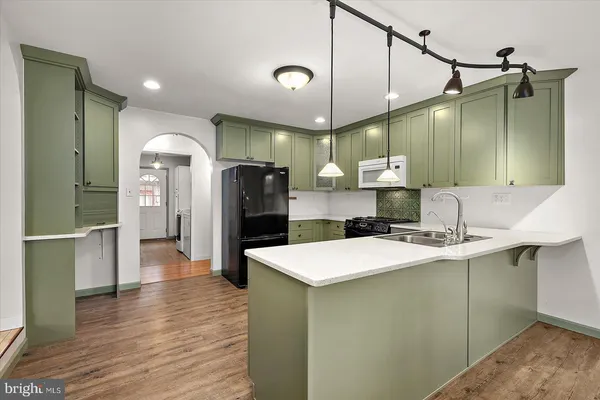 a kitchen with a sink and a refrigerator
