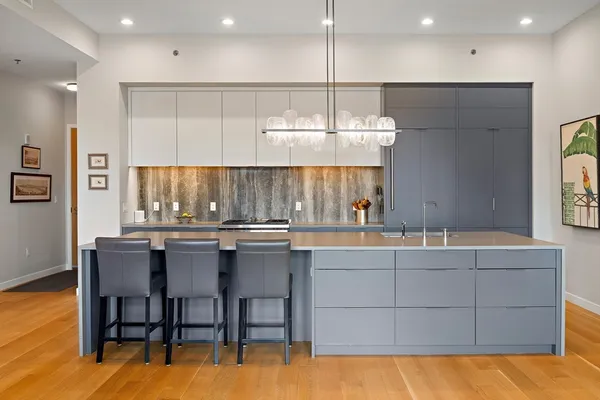 a kitchen with a table chairs sink and cabinets