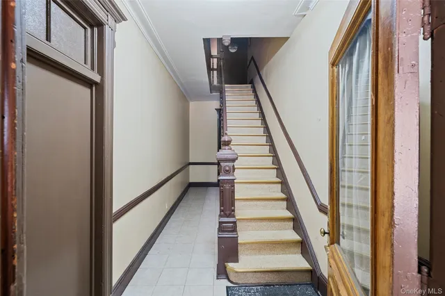 a view of staircase with wooden floor and white walls