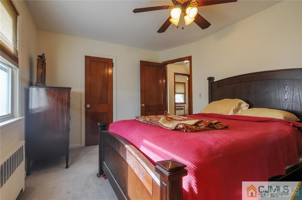 136 McFarlane Road Colonia, NJ 07067 - Photo 16 of 23 a bedroom with a bed and a chandelier