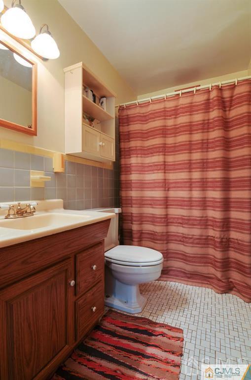 136 McFarlane Road Colonia, NJ 07067 - Photo 18 of 23 a bathroom with a sink toilet and shower
