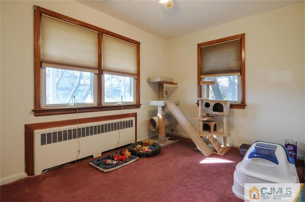 136 McFarlane Road Colonia, NJ 07067 - Photo 7 of 23 a room with gym equipment and a window