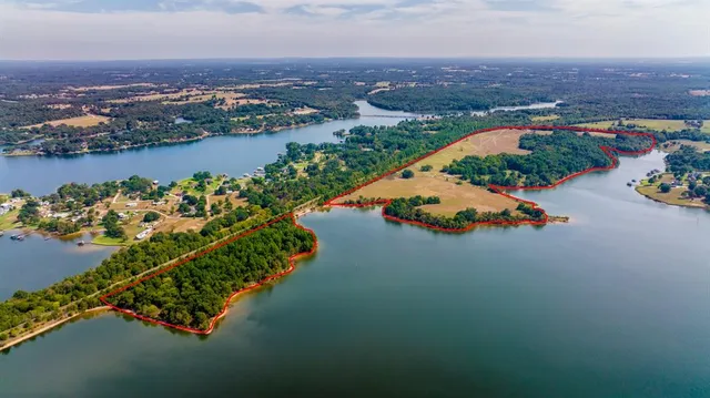 an aerial view of a houses with a lake view