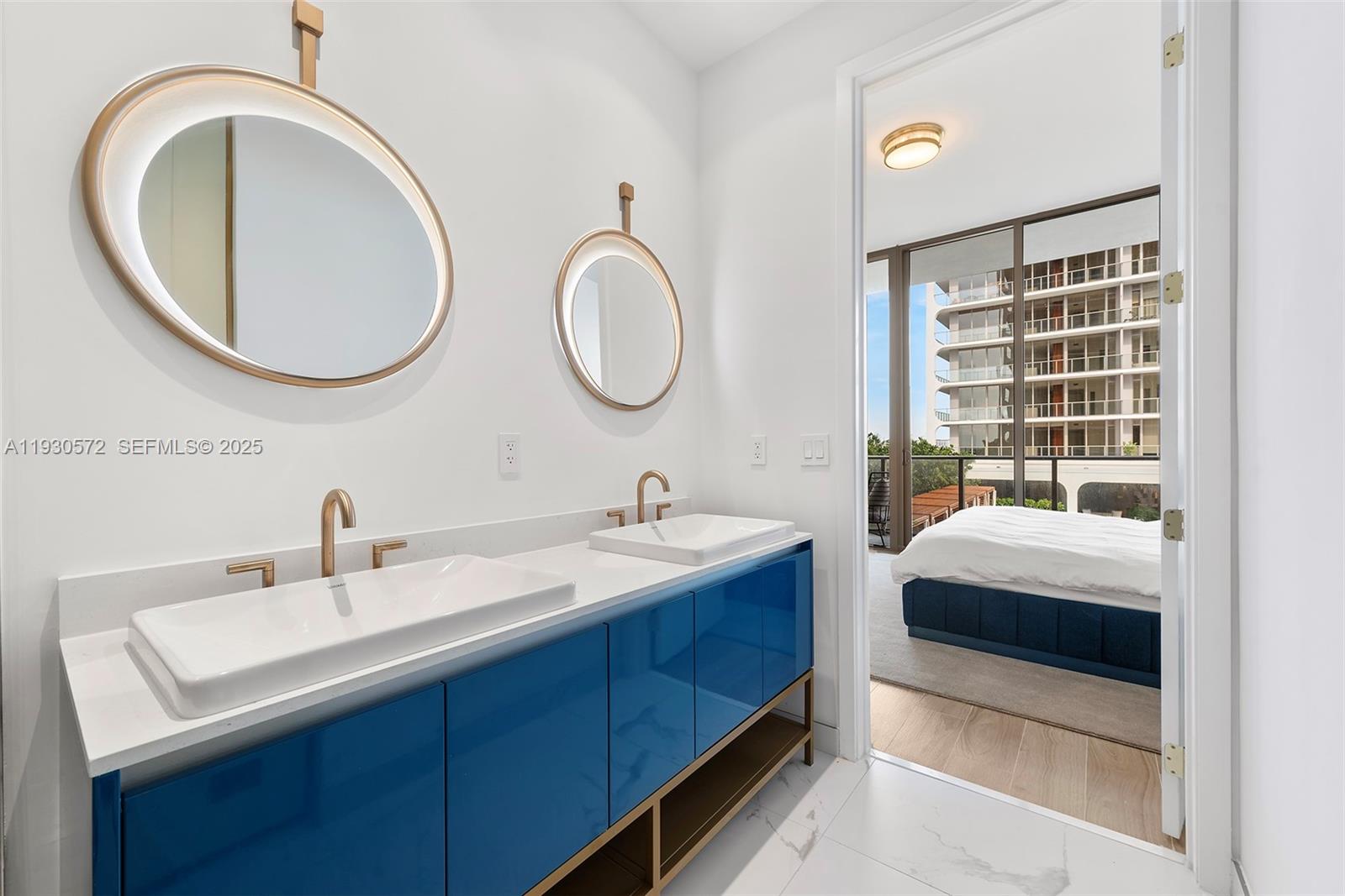 2655 South Bayshore Drive, Unit 909 Miami, FL 33133 - Photo 14 of 26 a bathroom with a double vanity sink and a mirror