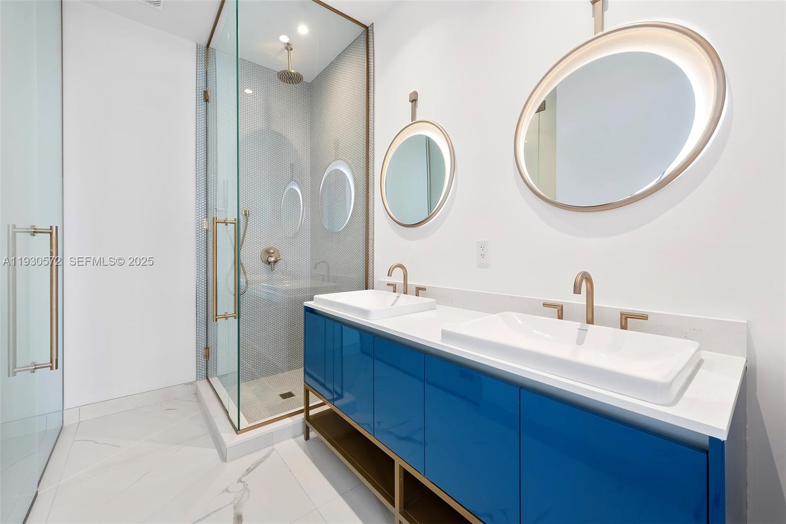 2655 South Bayshore Drive, Unit 909 Miami, FL 33133 - Photo 15 of 26 a bathroom with a double vanity sink and a mirror