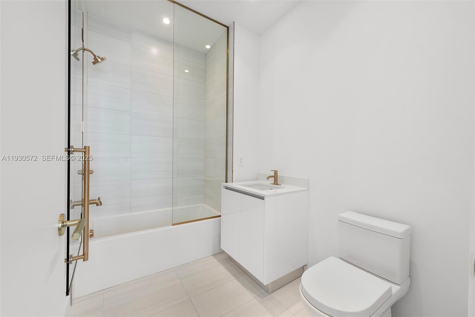 2655 South Bayshore Drive, Unit 909 Miami, FL 33133 - Photo 20 of 26 a bathroom with a toilet and a shower