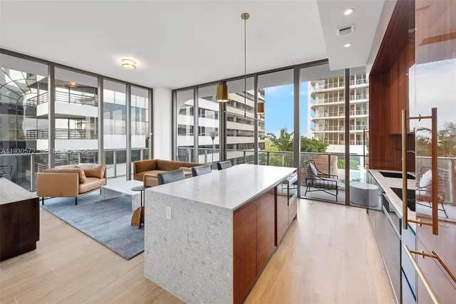 a living room with furniture and large windows