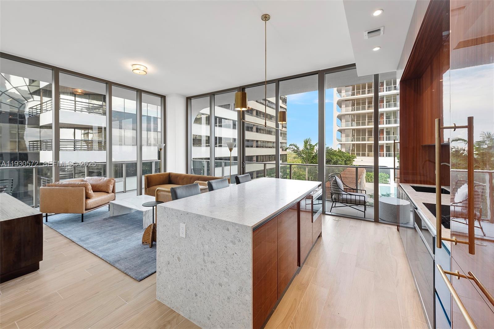 2655 South Bayshore Drive, Unit 909 Miami, FL 33133 - Photo 2 of 26 a living room with furniture and large windows