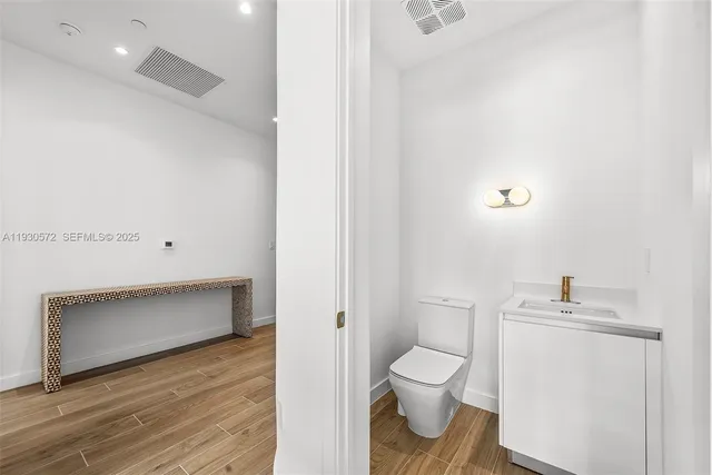 a view of a livingroom with wooden floor and closet