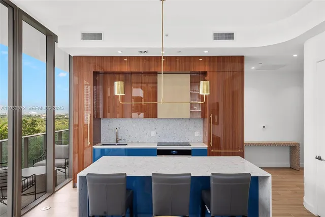 a kitchen with a refrigerator a sink and cabinets