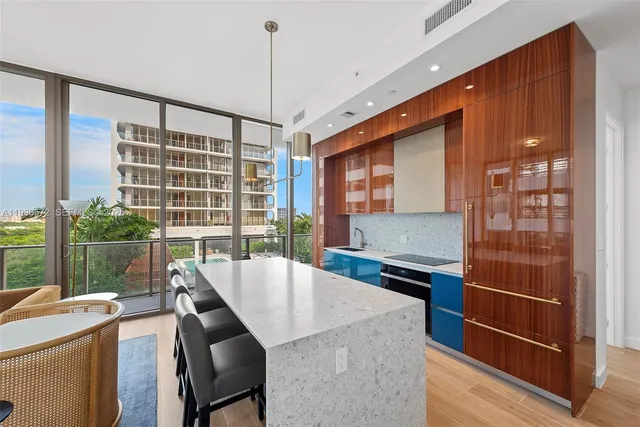 a kitchen that has a cabinets and a wooden table