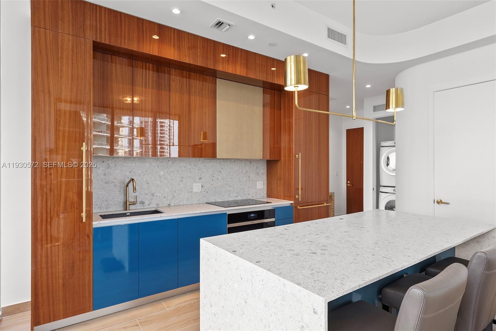 2655 South Bayshore Drive, Unit 909 Miami, FL 33133 - Photo 6 of 26 a kitchen that has a cabinets and a wooden table