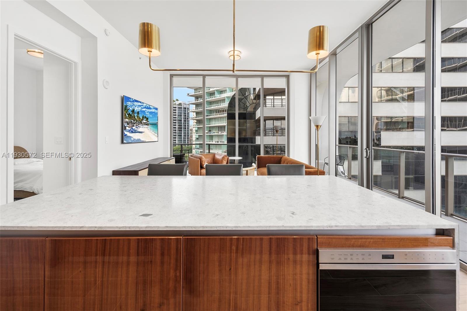 2655 South Bayshore Drive, Unit 909 Miami, FL 33133 - Photo 7 of 26 a view of a counter top space with furniture and floor to ceiling window