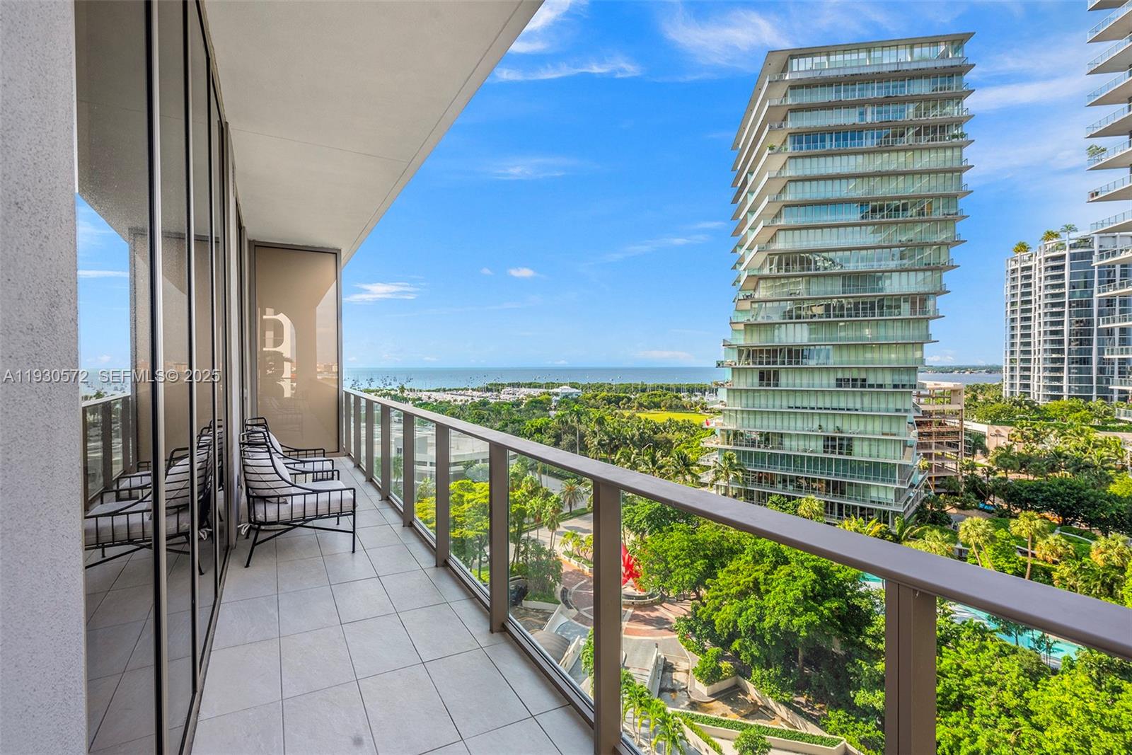 2655 South Bayshore Drive, Unit 909 Miami, FL 33133 - Photo 10 of 26 a view of a balcony with a potted plant