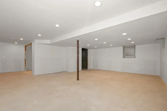 an empty room with a projector and furniture