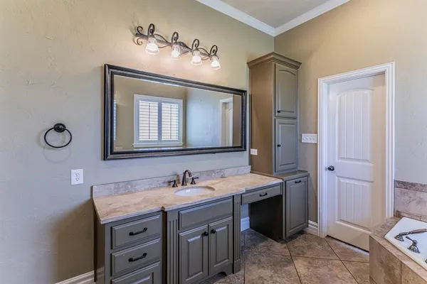 a spacious bathroom with a double vanity sink and a mirror