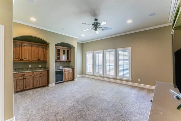 a large kitchen with stainless steel appliances granite countertop a large window