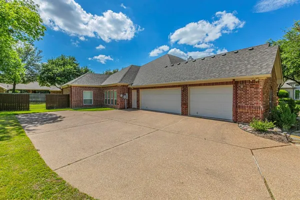 a front view of a house with a yard and a garage