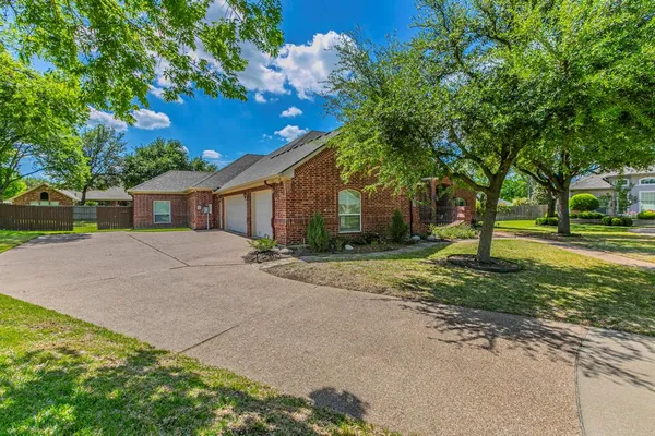 a front view of a house with a yard and a garage