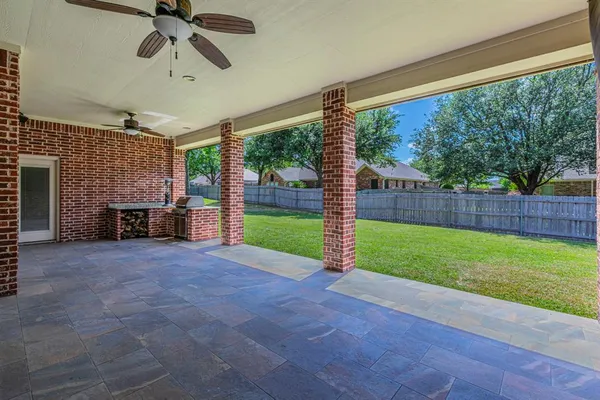 a view of a porch with furniture and garden