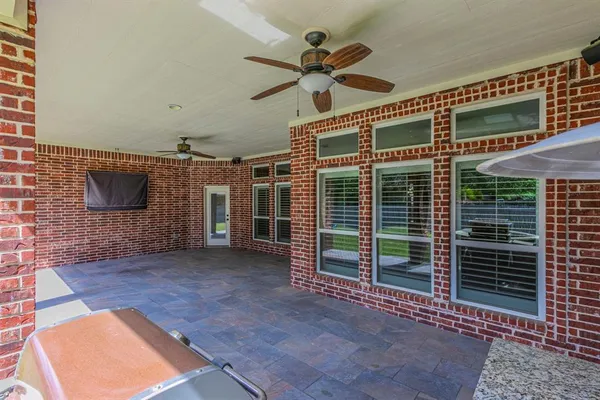 a view of a livingroom with a ceiling fan and a fireplace