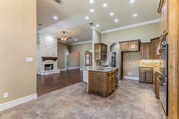 a kitchen with stainless steel appliances granite countertop a sink and cabinets