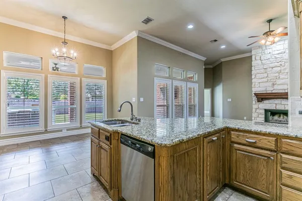 a kitchen with stainless steel appliances granite countertop a sink a stove a counter top space and cabinets