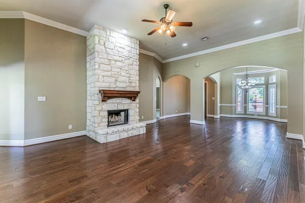 a view of an empty room with a fireplace and a window