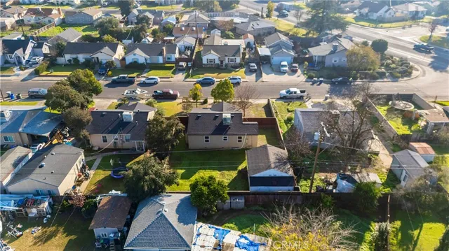 an aerial view of a houses with yard