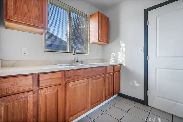 a kitchen with stainless steel appliances granite countertop a sink and a window