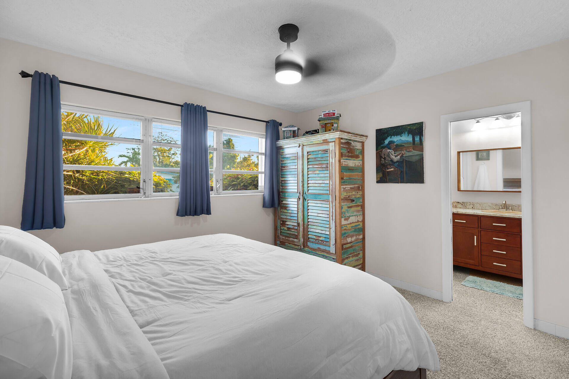 2801 Fogarty Avenue Key West, FL 33040 - Photo 4 of 53 a bedroom with a large bed and a dresser next to a window