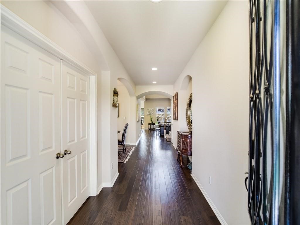 137 Nantucket Circle Austin, TX 78737 - Photo 11 of 34 a view of a hallway with wooden floor and staircase