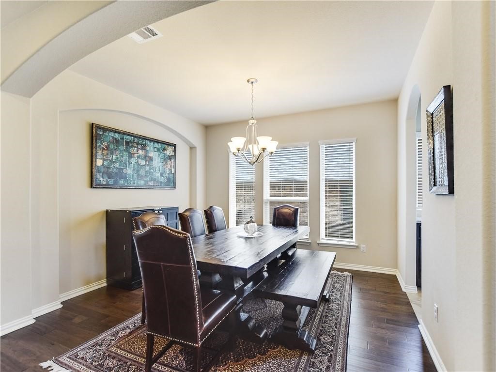 137 Nantucket Circle Austin, TX 78737 - Photo 12 of 34 a dining room with furniture a chandelier and wooden floor